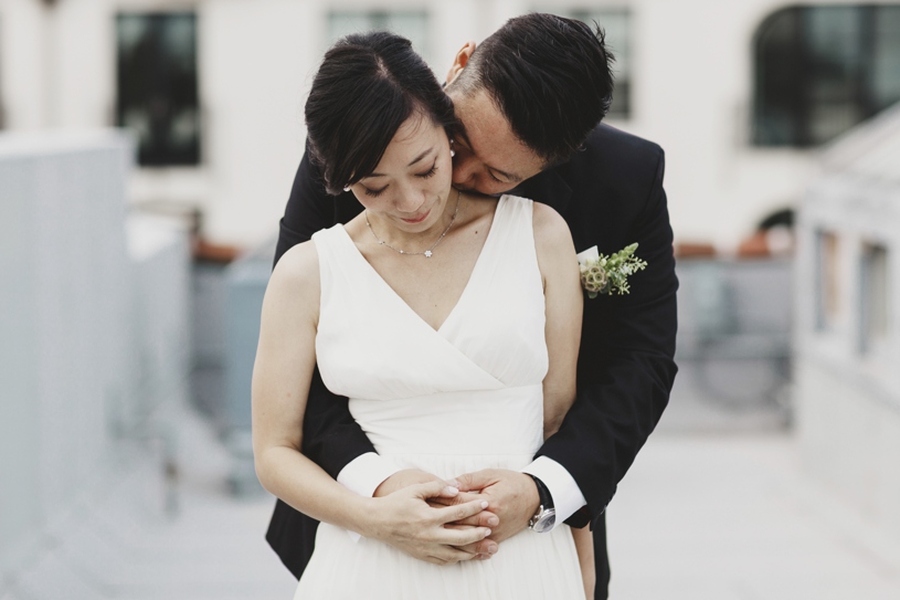 Bride and groom at their modern minimalistic green and white wedding at firehouse 8 by heather elizabeth photography